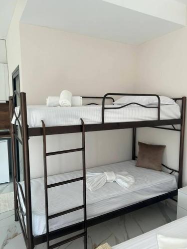 a couple of bunk beds in a room at Alex Studios Paralia Vrasna in Asprovalta