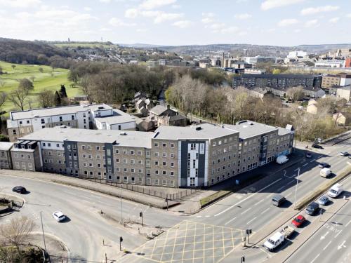 an aerial view of a city with a road and buildings at For Students Only - Saw Mill in Huddersfield in Huddersfield