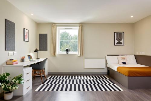 a bedroom with a bed and a desk and a window at For Students Only - Saw Mill in Huddersfield in Huddersfield