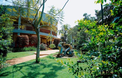 a couple of statues in front of a building at Greenyard Beach Hotel in Entebbe