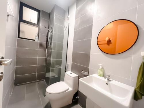 a bathroom with a toilet and a sink and a mirror at Ipoh The Cove Hillside Stay 7 to 10 pax, 5 min to Ipoh Town in Ipoh