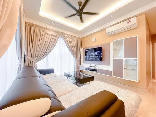 a living room with a couch and a ceiling fan at Ipoh The Cove Hillside Stay 7 to 10 pax, 5 min to Ipoh Town in Ipoh