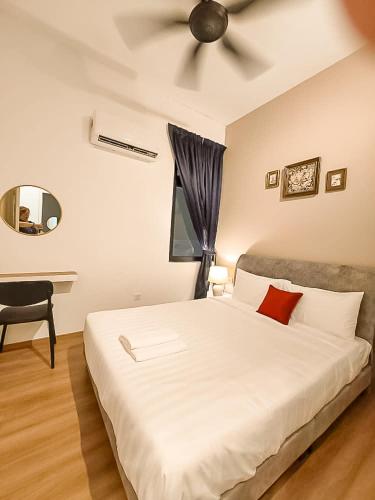 a bedroom with a white bed with a ceiling fan at Ipoh The Cove Hillside Stay 7 to 10 pax, 5 min to Ipoh Town in Ipoh