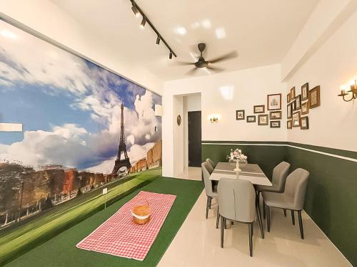 a dining room with a table and a painting of the eiffel tower at Ipoh The Cove Hillside Stay 7 to 10 pax, 5 min to Ipoh Town in Ipoh