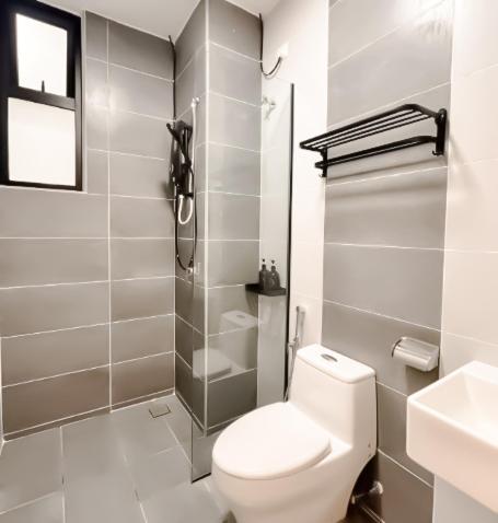 a white bathroom with a toilet and a sink at Ipoh The Cove Hillside Stay 7 to 10 pax, 5 min to Ipoh Town in Ipoh