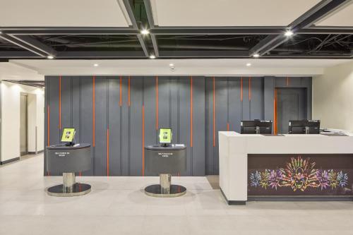a lobby with a counter and chairs in a room at Go Hotels Plus Bacolod - Newly Renovated in Bacolod