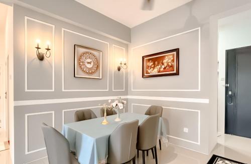 a dining room with a white table and chairs at Ipoh The Cove Hillside Stay 7 to 10 pax, 5 min to Ipoh Town in Ipoh