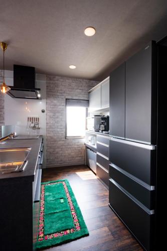 Una cocina o cocineta en ルグランみしま
