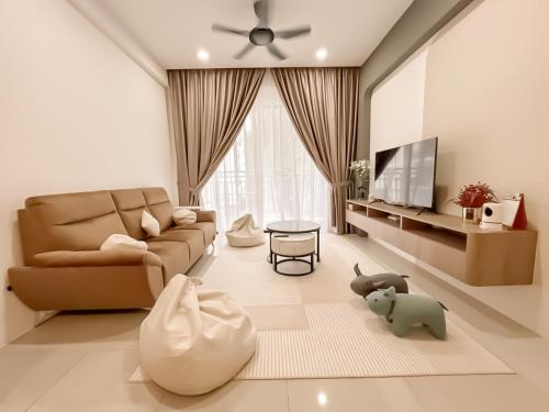 a living room with a couch and a tv at Ipoh The Cove Hillside Stay 7 to 10 pax, 5 min to Ipoh Town in Ipoh