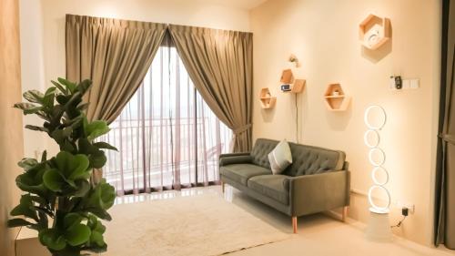 a living room with a couch and a large window at Ipoh The Cove Hillside Stay 7 to 10 pax, 5 min to Ipoh Town in Ipoh