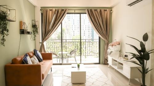 a living room with a couch and a balcony at Ipoh The Cove Hillside Stay 7 to 10 pax, 5 min to Ipoh Town in Ipoh