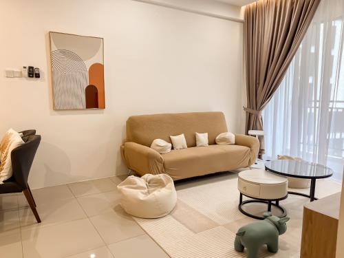 a living room with a couch and a table at Ipoh The Cove Hillside Stay 7 to 10 pax, 5 min to Ipoh Town in Ipoh