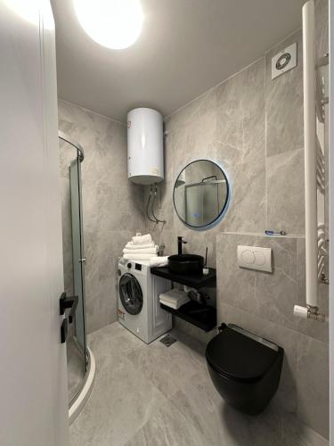 a bathroom with a sink and a washing machine at Pristina Luxury Apartments 46 in Pristina