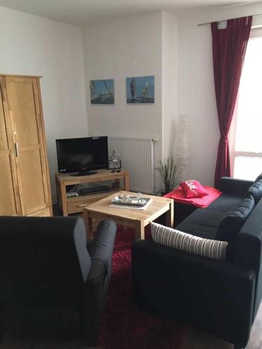 a living room with two couches and a coffee table at Ferienwohnungen Am Yachthafen in Greifswald