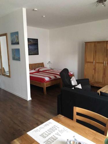 a living room with a bed and a couch at Ferienwohnungen Am Yachthafen in Greifswald