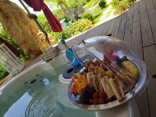 a bowl of food sitting on top of a swimming pool at Il Giardino dei Flintstones B&B in Cerveteri
