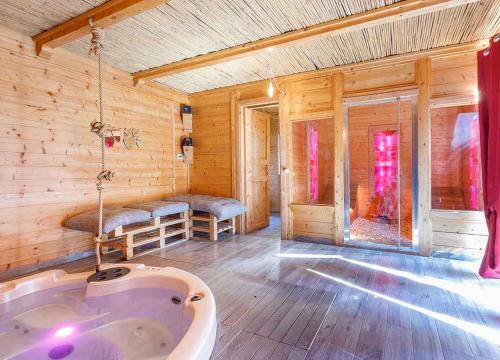 a bathroom with a tub in a wooden room at Il Giardino dei Flintstones B&B in Cerveteri