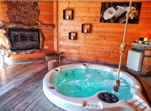 a bath tub in a room with a fireplace at Il Giardino dei Flintstones B&B in Cerveteri