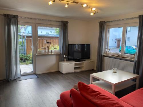 a living room with a couch and a tv at Ferienwohnung Bianca in Ettenheim