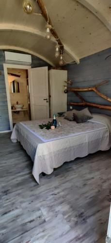 a bedroom with a large bed in a room at Il Giardino dei Flintstones B&B in Cerveteri