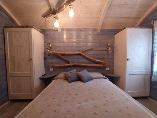 a bedroom with a bed with a wooden wall at Il Giardino dei Flintstones B&B in Cerveteri