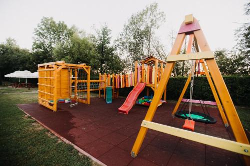 a row of playground equipment in a yard at Szépasszony Guest House in Vlăhiţa