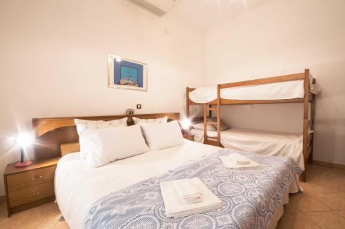a bedroom with a bed and a bunk bed at Villa Petra, a romantic and spectacular villa near the sea in Kukci