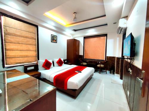 a bedroom with a bed and a flat screen tv at Daanish Residency in Karol Bagh Delhi Near Ganga Ram Hospital in New Delhi