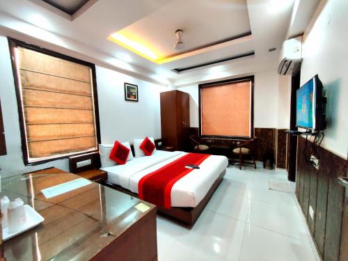 a bedroom with a bed and a television in it at Daanish Residency in Karol Bagh Delhi Near Ganga Ram Hospital in New Delhi