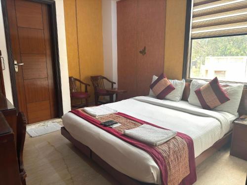 a bedroom with a large bed with a window at Daanish Residency in Karol Bagh Delhi Near Ganga Ram Hospital in New Delhi