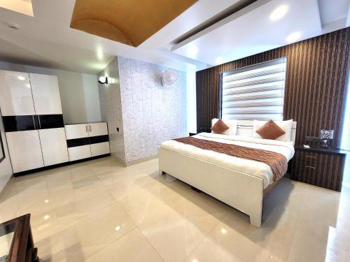 a bedroom with a large bed in a room at Daanish Residency in Karol Bagh Delhi Near Ganga Ram Hospital in New Delhi