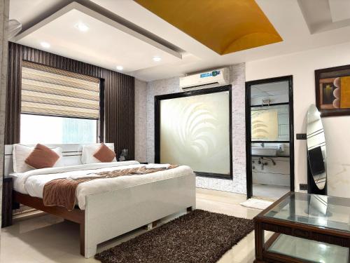 a bedroom with a bed and a large window at Daanish Residency in Karol Bagh Delhi Near Ganga Ram Hospital in New Delhi