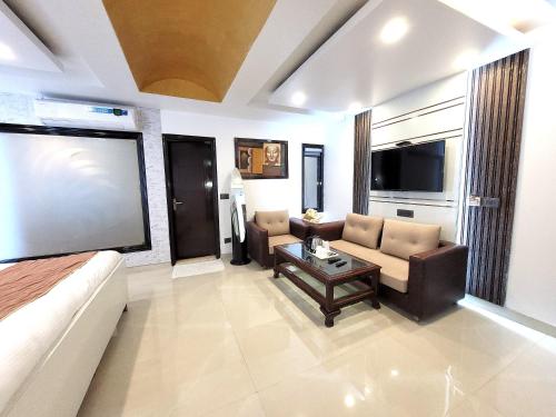 a living room with a couch and a table at Daanish Residency in Karol Bagh Delhi Near Ganga Ram Hospital in New Delhi