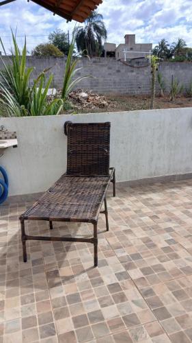 a wooden bench sitting on a tile patio at Recharge your batteries Arca da Aliança Chalet in Limeira