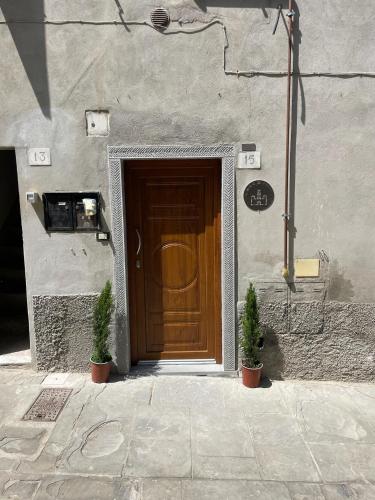 a door to a building with two plants in front of it at Il Nido di Poppi in Poppi