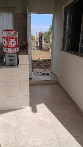 a chair sitting in the doorway of a house at Recharge your batteries Arca da Aliança Chalet in Limeira
