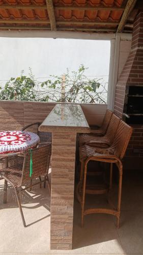 a table and chairs on a patio with a table and a table and a table at Recharge your batteries Arca da Aliança Chalet in Limeira