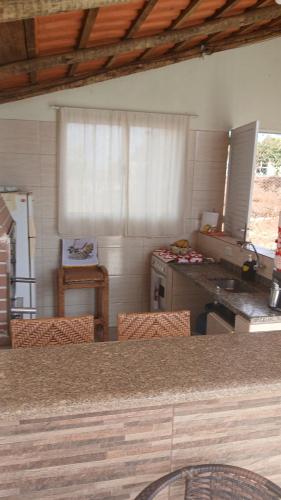a kitchen with a table and chairs and a counter top at Recharge your batteries Arca da Aliança Chalet in Limeira