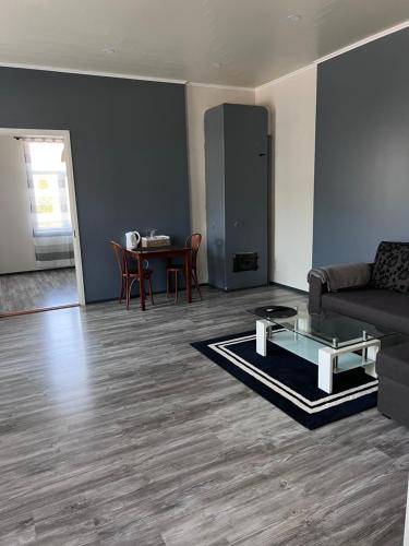 a living room with a couch and a table at City Center Apartment in Valga