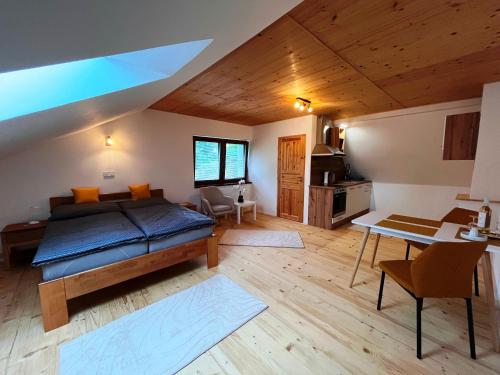 a bedroom with a bed and a table in a room at Apartmán Kunratice 2 in Kunratice