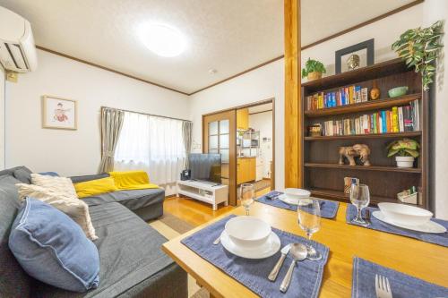 a living room with a couch and a table at NEW Koenji House 3BR Family Friendly Haven in Tokyo