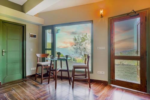 a dining room with a table and chairs and a window at SaffronStays Edelweiss Estate Amore in Chaubattia