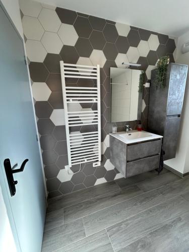 a bathroom with a sink and a mirror at Gite Clé des Champs in Montenois