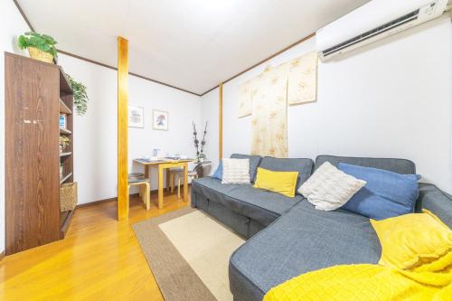 a living room with a blue couch and a table at NEW Koenji House 3BR Family Friendly Haven in Tokyo