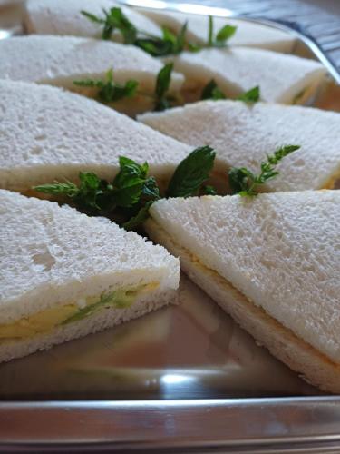 a plate of sandwiches with greens on top of it at La Casa di Linda in Mirano