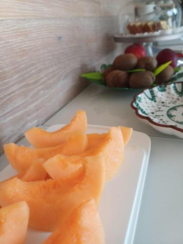 a white plate with orange slices on a table at La Casa di Linda in Mirano