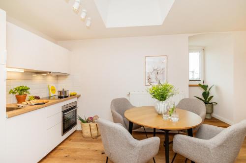 a kitchen and dining room with a table and chairs at Apartments am Bahnhof in Stralsund