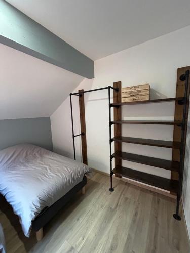 a bedroom with a bunk bed and a book shelf at Gite Clé des Champs in Montenois