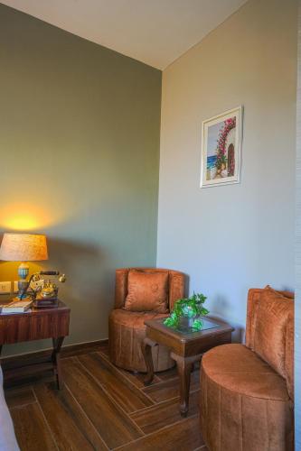 a living room with a chair and a table at SaffronStays Edelweiss Estate Amore in Chaubattia