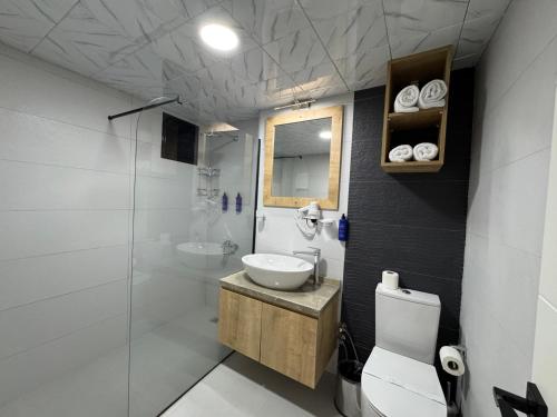 a bathroom with a sink and a toilet and a shower at Alican 1 Hotel in Izmir